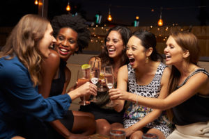 Five women sharing a toast of champagne flutes