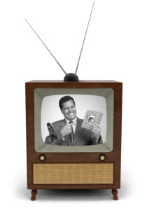A pitcman with product in hand on an old tube TV set with rabbit ear antenna.